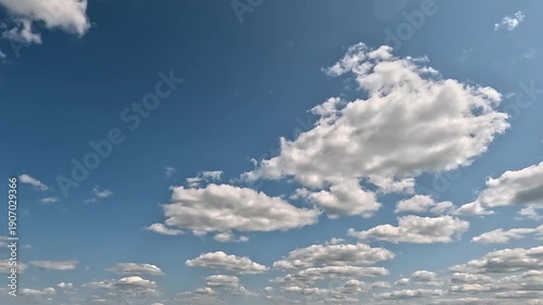 Stunning endless clouds flight forward 4K video (Ultra High Definition) of cloudscape and bright sun. Sky and clouds Timelapse. Sun shines through the clouds on the blue sky background.