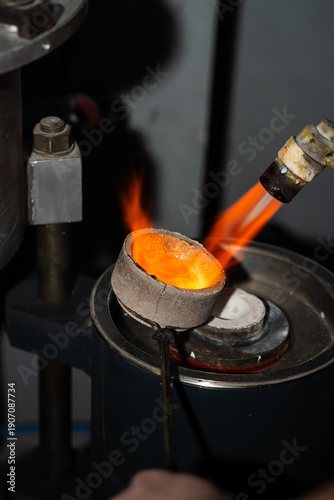 Fotografie Jeweler precise gold melting in crucible with gas torch.