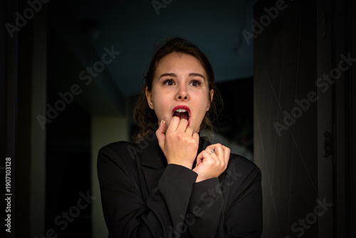 Canvas Print woman in a doorway screams in fear, her face showing intense surprise and terror, emphasizing emotions of shock and fright