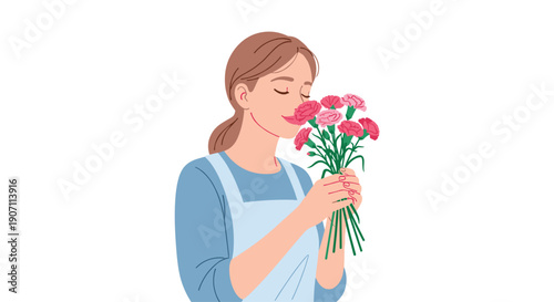 A smiling young woman wearing an apron stands with her eyes closed, gently holding a bouquet of pink flowers and smelling their fragrance.