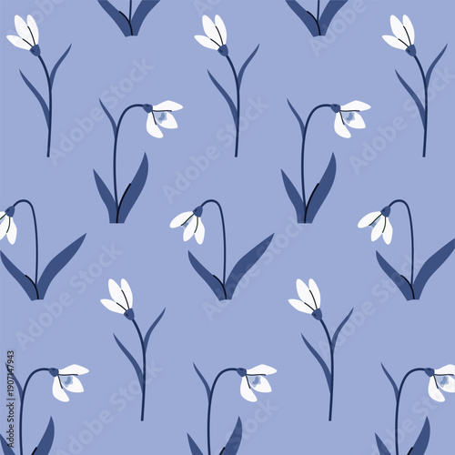 Seamless pattern of snowdrop flowers on a blue background, ideal for fabric, wallpaper, or wrapping paper designs. Early spring flowers. Blossom nature wildflowers.