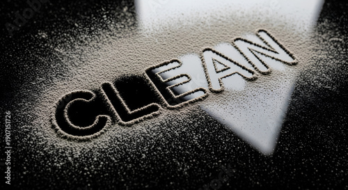 Clean Dust Text. Word written in white powder on black surface. Hygiene and housekeeping concept. Dirty surface wiped clear. Cleaning service background