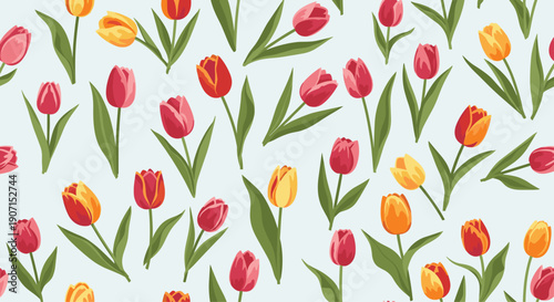 Elegant seamless pattern with red, pink, and yellow tulips on a soft light blue background perfect for spring textiles and wallpapers.