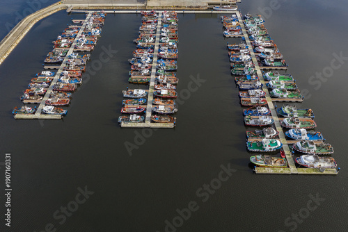 fishing boats on the pier in the port aerial view