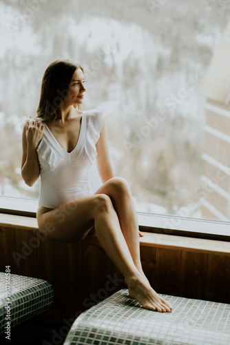 Woman in a white swimsuit s...