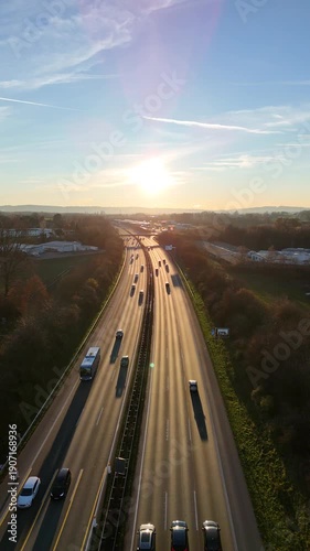 Aerial highway traffic at sunset cars and trucks on motorway