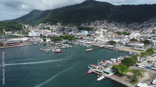 Angra Dos Reis, Brazil, January 13, 2025: Circling Drone shot of Angra dos Reis, the harbour area and the characteristic surrounding mountains with green rainforest behind the city and the harbour
