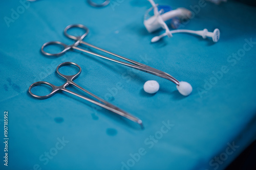 Surgical Forceps Holding Sterile Cotton on Operating Table