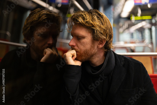 Fotografía Young man reflecting on thoughts during subway travel