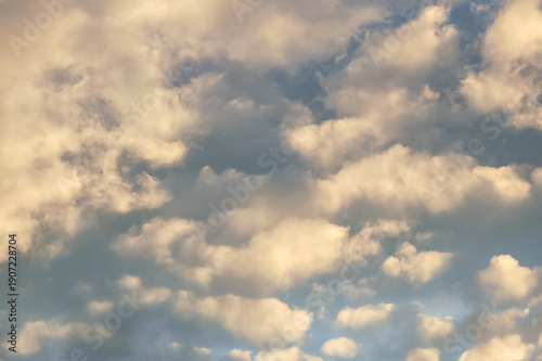 Photography Puffy white backlit clouds in a blue afternoon sky