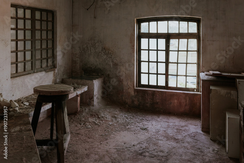 Rustic abandoned room with old wooden furniture and window