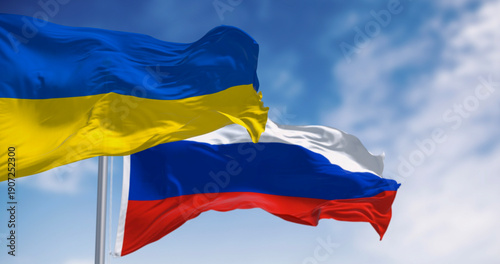 Canvas Print National flags of Ukraine and Russia waving on a clear day