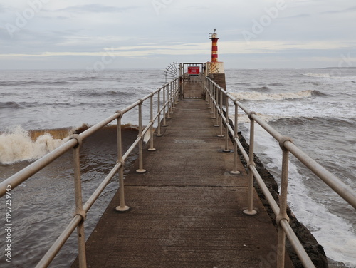 Amble lighthouse and pier. Northumberland uk in winter