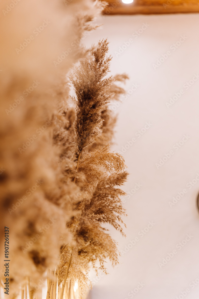 Obraz premium Boho fireplace mantel with macrame wall hanging, candles and dried flowers