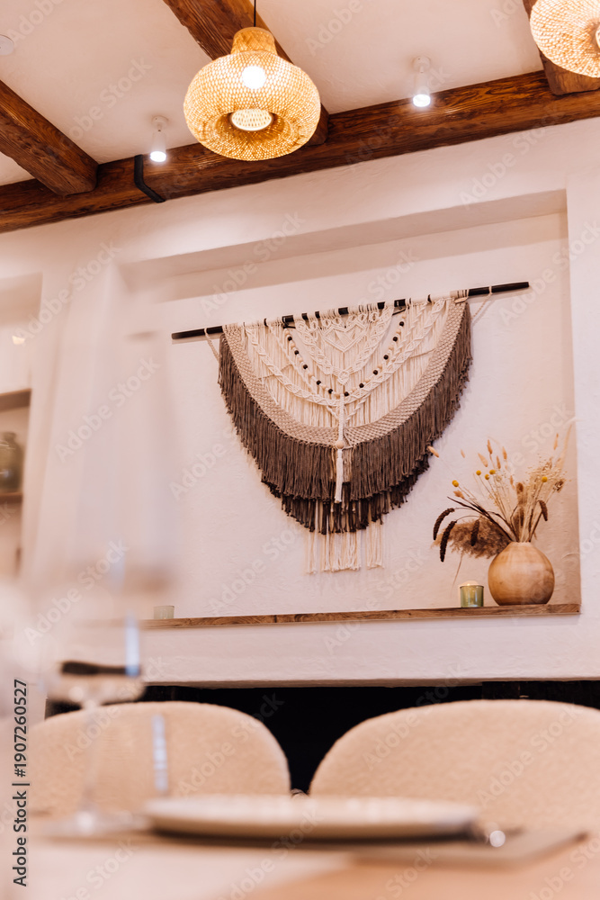 Obraz premium Boho fireplace mantel with macrame wall hanging, candles and dried flowers