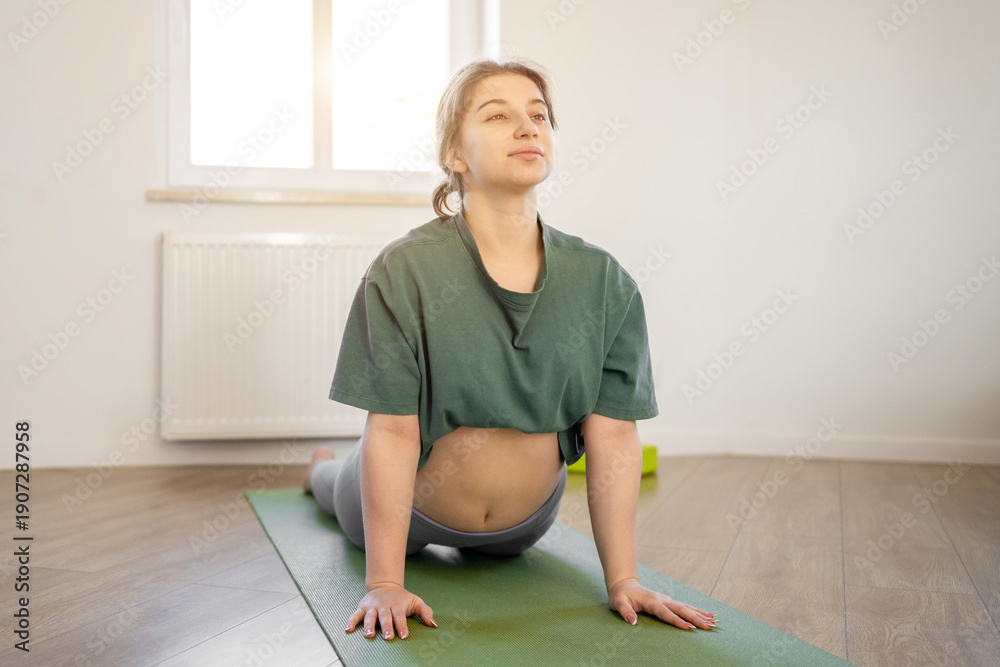 Obraz premium Young Girl Doing Exercises On Yoga Mat At Home