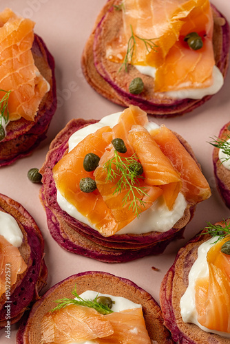 Vászonkép Close up of  pink Beetroot Pancakes or blini with Smoked Salmon, stracciatella, cappers