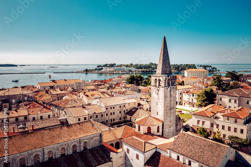 Wallpaper Mural Aerial view of the ancient Euphrasian Basilica's bell tower piercing the skyline amidst terracotta rooftops, overlooking the Adriatic, Porec, Istria County, Croatia. Torontodigital.ca