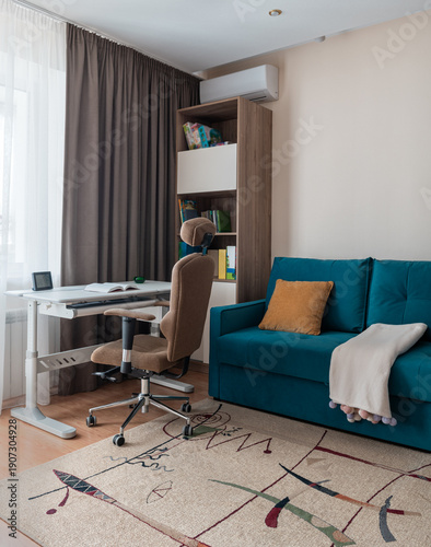 Bright room for teenager with blue sofa, bookshelves and transforming desk