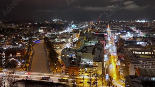 Night Aerial View of Frozen Aurajoki River and Turku Cityscape in Winter, Finland, 4K