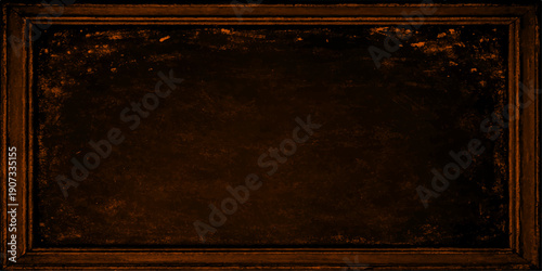 An empty vintage photo frame with an aged metal design rests on a dark grunge wooden board featuring a rough brown texture and a dirty antique paper surface