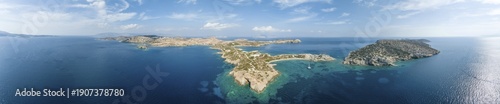 Aerial view, sailing catamaran in a bay on the Turquoise Sea, panorama of the island of Schinoussa, Small Cyclades, Greece