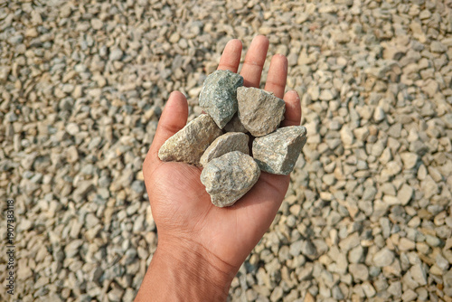 Crushed stone aggregate in hand commonly used in various landscaping and construction projects