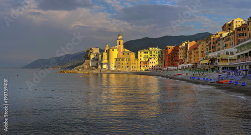 Colorful houses and fortress of the city of Camogli in the light of sunset, c...