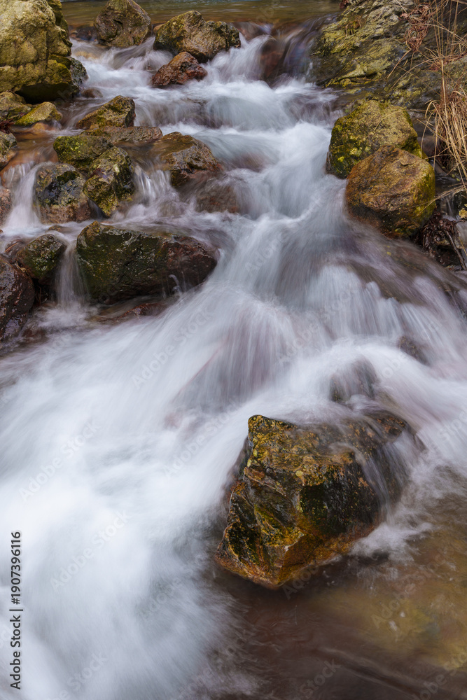 Fototapeta premium Arditurri Waterfall in Aiako Harria. Small waterfall on the Arditurri River in Aiako Harria Natural Park, Gipuzkoa, captured with a silk effect to enhance its natural beauty.