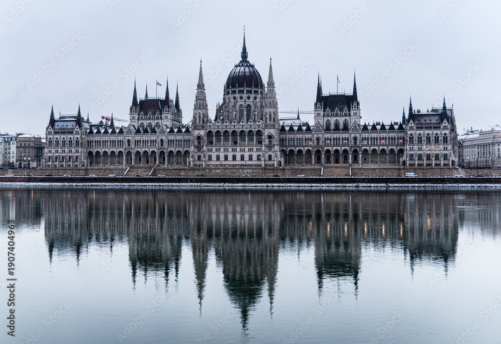 Obraz premium Parliament building in the old historic city of Budapest next to the Danube River, at the morning, covered with snow. Budapest, capital of Hungary.