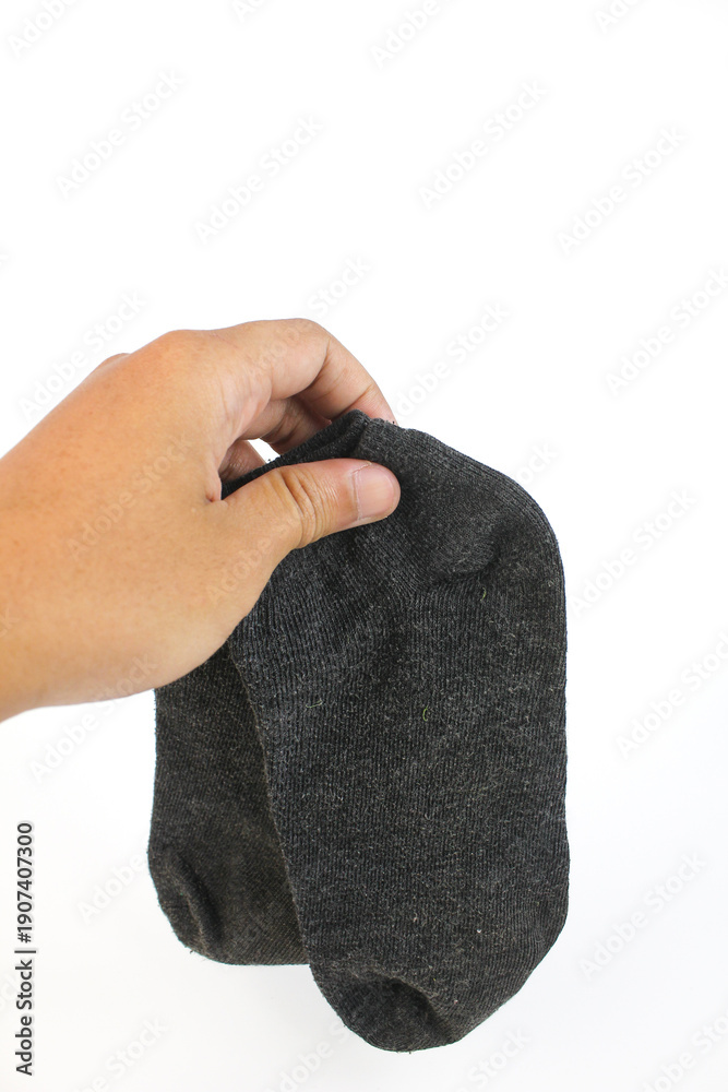 Obraz premium hand holding socks isolated on white background