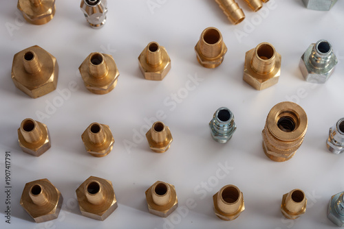 Large collection of brass and steel pneumatic fittings including hose barbs and quick couplers, professional industrial hardware assortment for fluid engineering and workshop maintenance systems