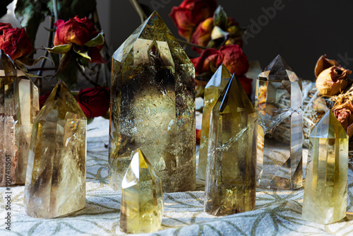 Several tall citrine crystal towers lined up on a crystal grid cloth with  sacred geometry.