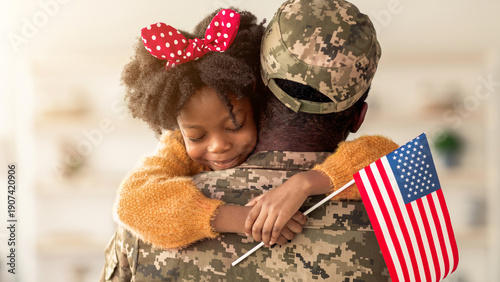 Schilderij op canvas A child with curly hair and a red bow hugs a soldier wearing a camouflage uniform