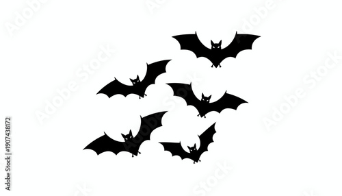 Group of black bats flying together in formation.
