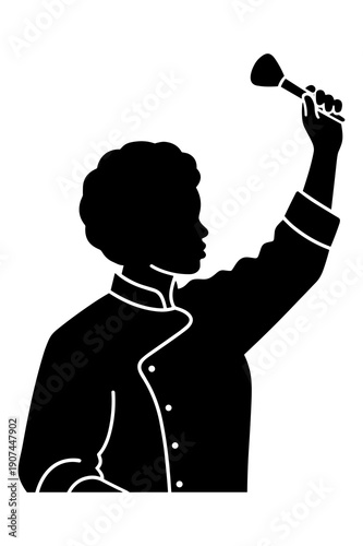 Silhouette of professional chef proudly holding up a basting brush aloft