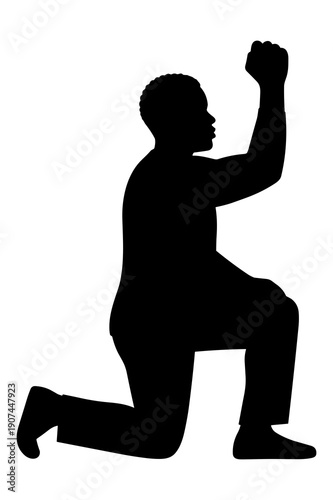 Silhouette of man kneeling with raised fist symbolizing victory or protest