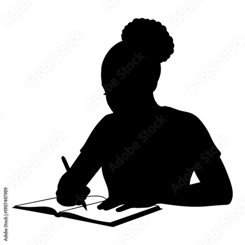 Silhouette of a focused student writing in an open book or notebook