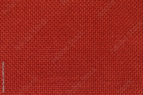 Detailed texture of brick red woven fabric background. Top view of warm textile material with a basket weave pattern