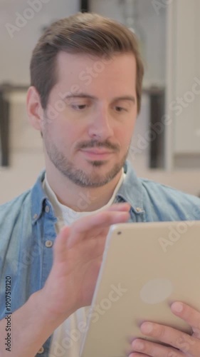 Portrait of Young Man using Tablet Computer, vertical video