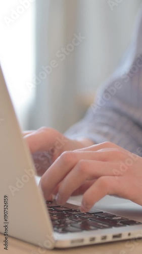 Close Up of Young Woman Typing on Laptop, vertical video