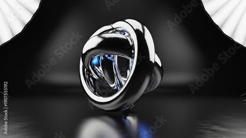 Abstract chrome knot sculpture in a dark studio setting with soft lighting