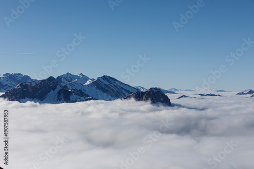 Stunning landscape with snow-capped mountains and fluffy clouds. Capture the beauty of nature.