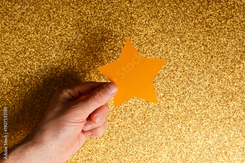 Hand holding a star against...