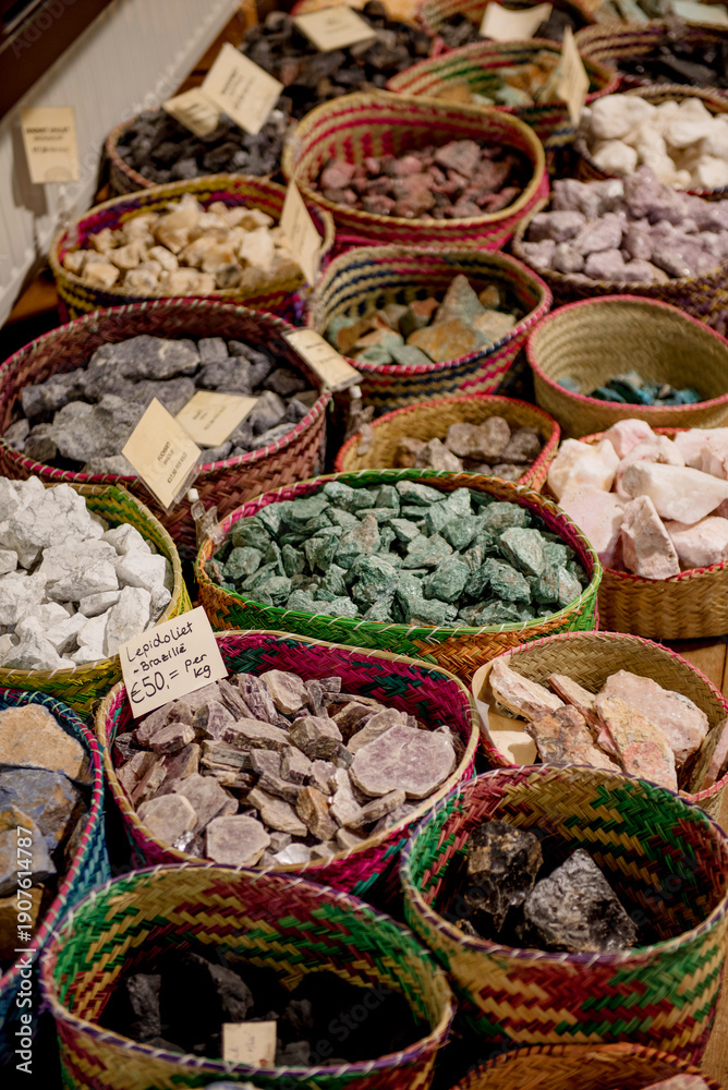 Fototapeta premium Giethoorn, Netherlands, April 08 2018: A vibrant display of colorful gemstones and crystals in woven baskets at a local shop