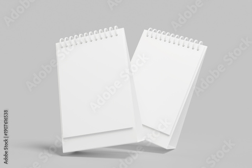 Two Desktop Spiral Bound Calendars Against Gray Background