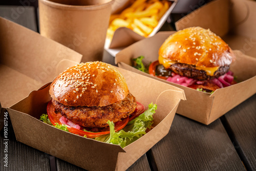 Two fresh burgers in eco takeaway packaging