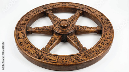 An ornate wooden wheel with intricate carvings and symbols on a white background