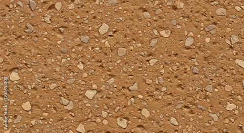 Close-up texture of a sandy brown surface with small pebbles and grains.