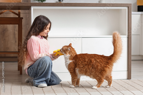 Cute little girl feeding fl...
